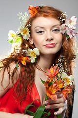 Image showing Portrait of beautiful woman with spring flowers