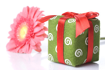 Image showing Gift with pink daisy-gerbera on white