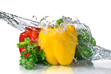 Image showing red, yellow, green pepper and parsley with water splash isolated