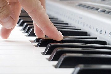 Image showing hand playing music on the piano