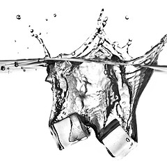 Image showing ice cubes dropped into water with splash isolated on white