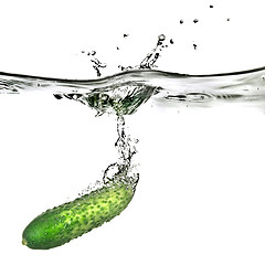 Image showing green cucumber dropped into water isolated on white