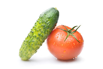 Image showing red tomato and green cucumber with water drops isolated on white