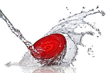 Image showing red beet with water splash isolated on white