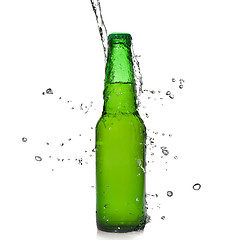 Image showing Green beer bottle with water splash isolated on white