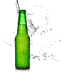 Image showing Green beer bottle with water splash isolated on white