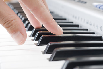 Image showing hand playing music on the piano