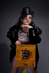 Image showing Old-style portrait of lady with vintage camera