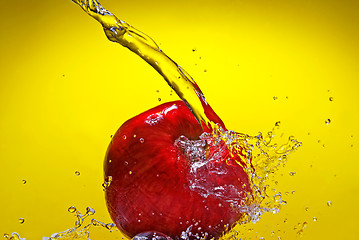 Image showing Green apple with water splash on blue background