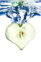 Image showing heart from green apple in water with splash isolated on white
