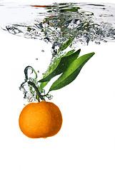 Image showing Splash of orange to water with bubbles of air