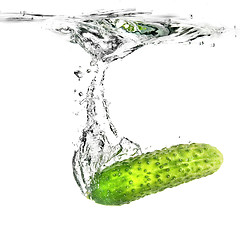 Image showing green cucumber dropped into water isolated on white