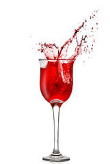 Image showing splash of red wine in goblet isolated on white