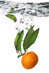 Image showing Splash of orange to water with bubbles of air