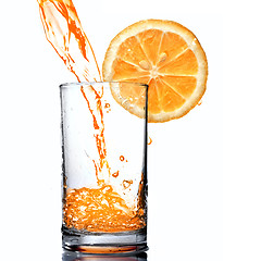 Image showing orange juice pouring into goblet with orange slice