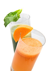 Image showing fresh juices from carrot and parsley in glasses isolated on white