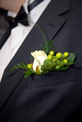 Image showing wedding buttonhole with rose on mans suite