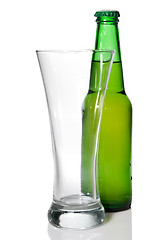 Image showing Beer bottle and empty glass isolated on white
