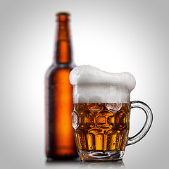 Image showing Beer in glass with water drops isolated on white 