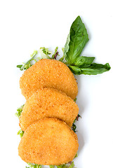 Image showing spicy cheese cakes with green leaves on the plate