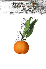 Image showing Splash of orange to water with bubbles of air