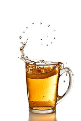 Image showing arranged bubbles of tea and lemon dropped into cup with splash