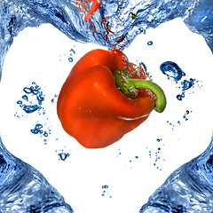 Image showing Red pepper with shape of heart from blue water isolated on white