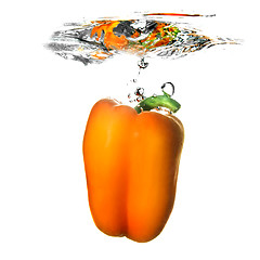 Image showing Yellow pepper dropped into water with bubbles isolated on white