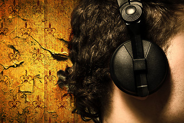 Image showing urban style photo of the man in headphones listening to musiñ
