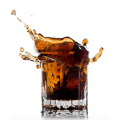 Image showing splash of cola in glass isolated on white