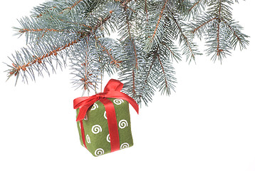 Image showing Christmas gift on fir tree branch isolated on white