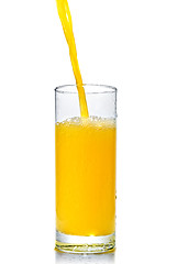 Image showing orange juice poring into glass isolated on white