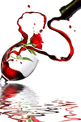 Image showing Heart from pouring red wine in goblet isolated on white