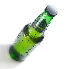 Image showing Green beer bottle with water drops isolated on white