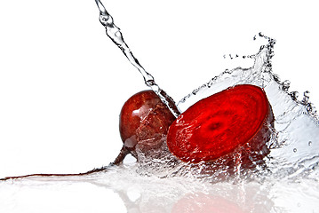 Image showing red beet with water splash isolated on white