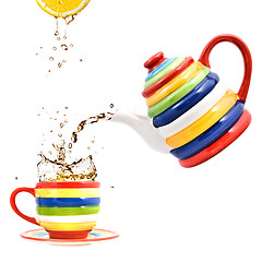 Image showing color teapot with cup and lemon isolated on white