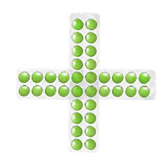 Image showing cross from packs of green tablets isolated on white
