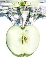 Image showing green apple dropped into natural water with splash isolated on w