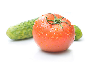 Image showing red tomato and green cucumber with water drops isolated on white