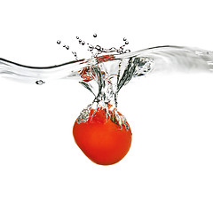 Image showing red tomato dropped into water isolated on white