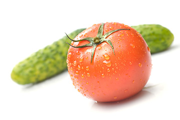 Image showing red tomato and green cucumber with water drops isolated on white