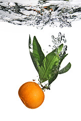 Image showing Splash of orange to water with bubbles of air