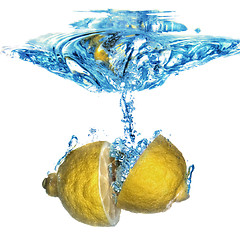 Image showing lemon dropped into water with bubbles isolated on white