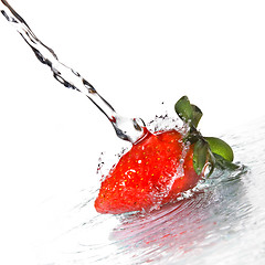 Image showing Fresh strawberry and water splash isolated on white