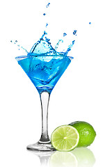Image showing Blue curacao cocktail with splash and green lime isolated on whi