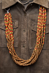 Image showing brown shirt with color necklace