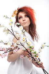 Image showing Portrait of beautiful woman with spring flowers on white