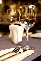 Image showing wineglass on served table in restaurant