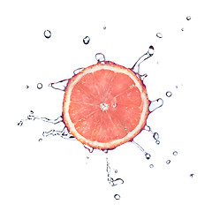 Image showing Slice of grapefruit with water drops isolated on white