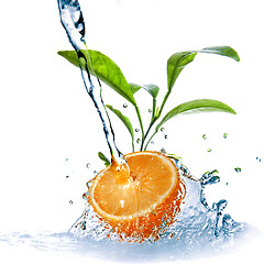 Image showing water drops on orange with green leaves isolated on white